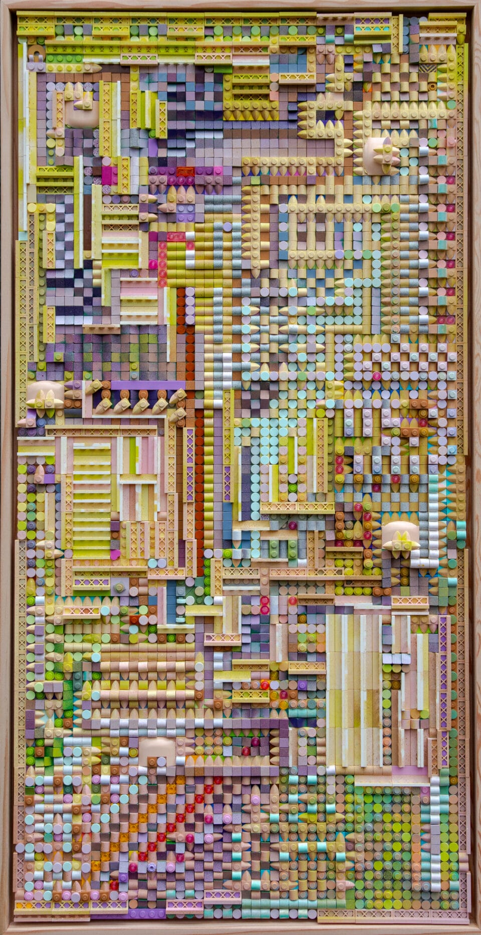 This artwork consists of a 48 by 96 rectangular grid of Lego covered in mainly single plates, tiles, cheese slopes, bumps and spikes as well as four by one fencing. The colours are predominantly pastel greens, blues, purples, pinks and beiges with some red, as well. Sometimes the colours are arranged in straight or diagonal lines or regular patterns, but mostly they are more diffuse.